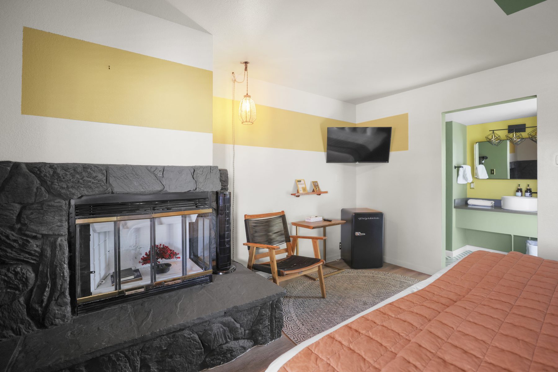 Yellow walls with stone fireplace